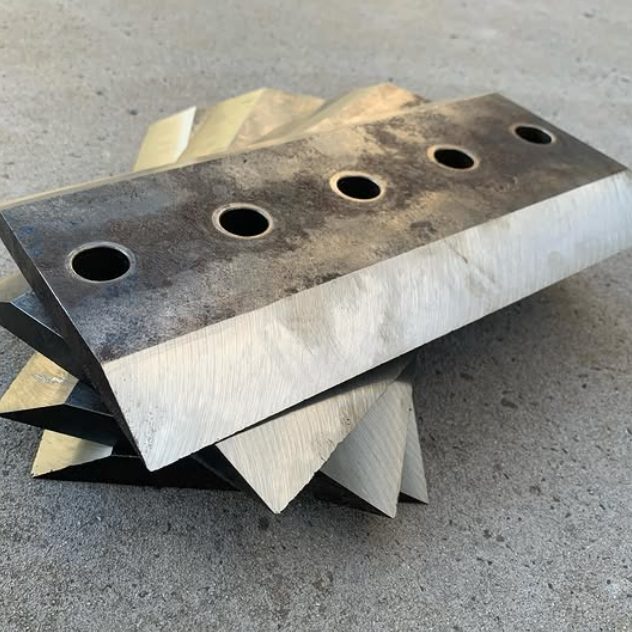 A stack of chipper blades with freshly ground bevels