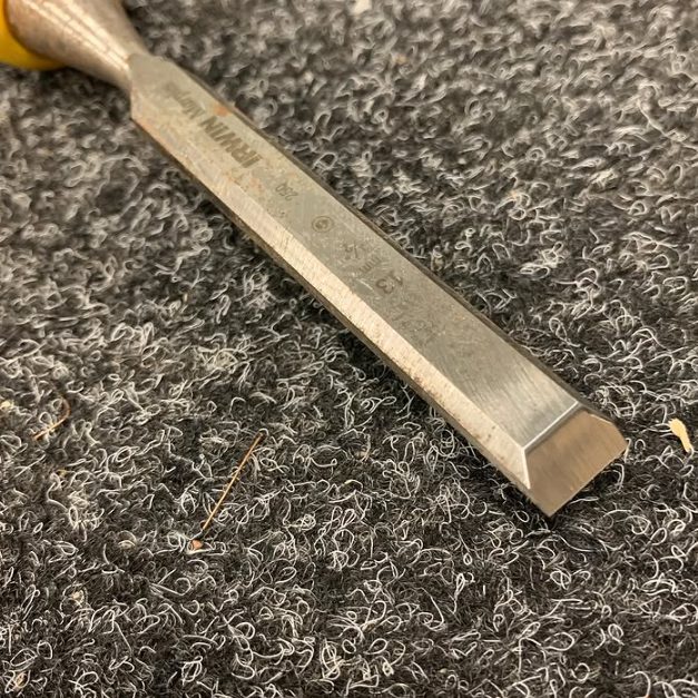 A wood chisel sharpened to a clean, square bevel