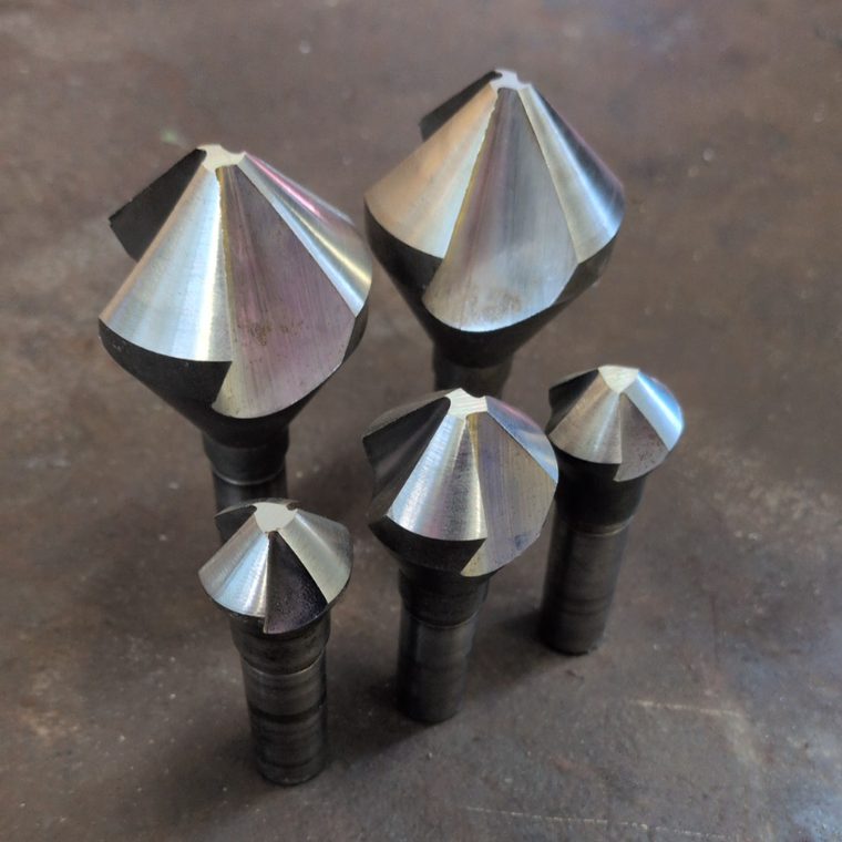 Five countersink bits of different sizes, sharpened to clean cutting edges