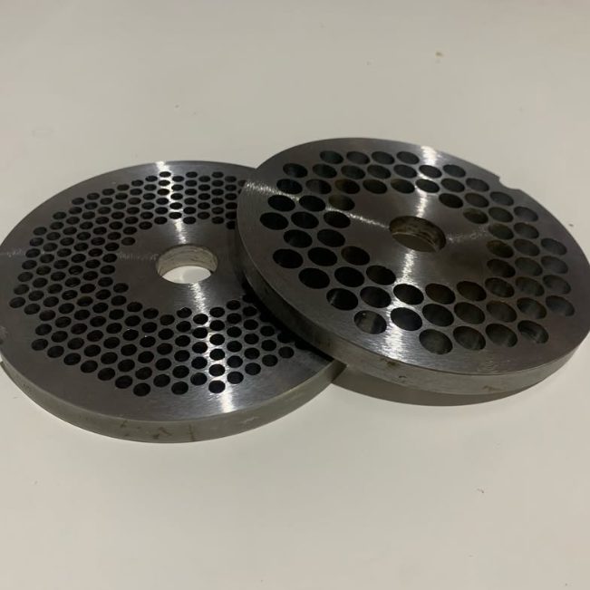 Two mincer plates sharpened flat, ready to go back into the butcher's mincer
