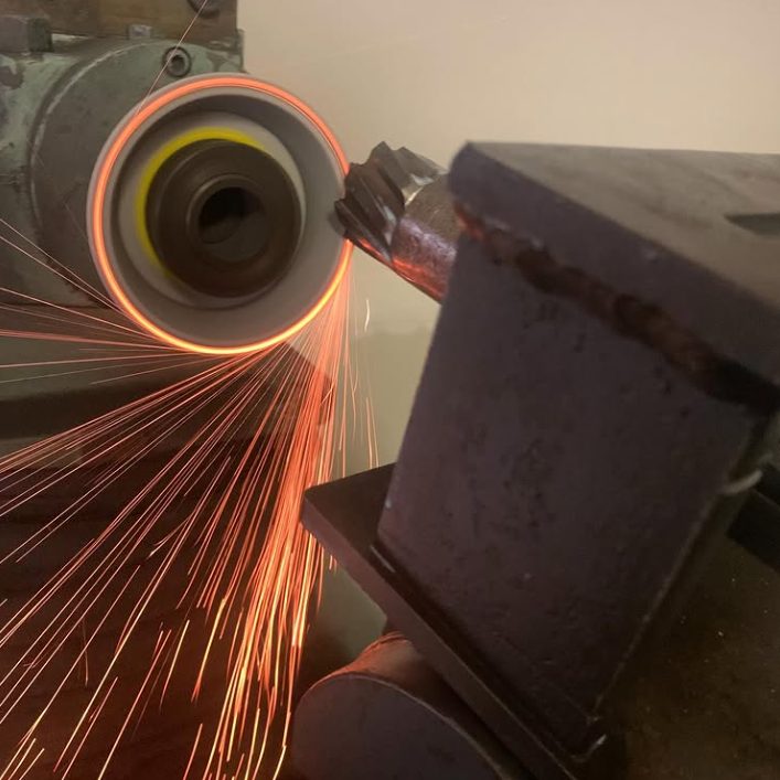 An annular cutter held against the grinding wheel at the Bunbury workshop