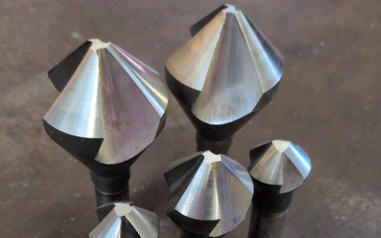 Five countersink bits of different sizes, sharpened to clean cutting edges
