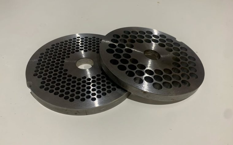 Two sharpened mincer plates, one of the tools not listed on the services page